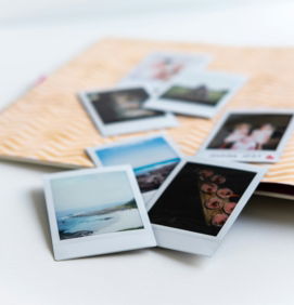 photos on white wooden table